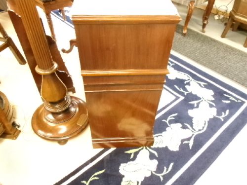 A Victorian mahogany storage unit featuring a white marble top, four inlaid drawers with brass handles, and four open lower vertical compartments. View VI