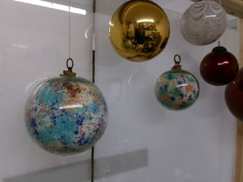 A collection of six assorted antique Victorian hand-blown glass witch balls in gold, red, and speckled colourways suspended by string. View VIII