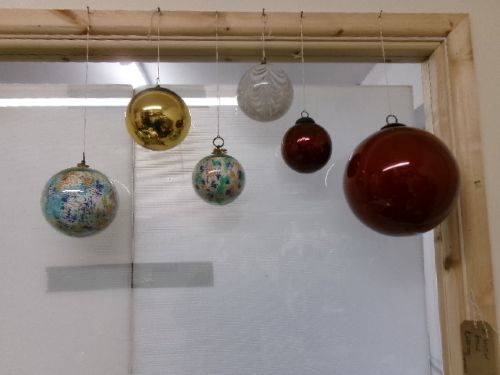 A collection of six assorted antique Victorian hand-blown glass witch balls in gold, red, and speckled colourways suspended by string. View XII