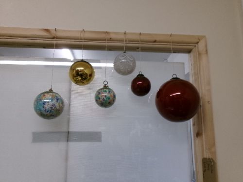 A collection of six assorted antique Victorian hand-blown glass witch balls in gold, red, and speckled colourways suspended by string. View XIII
