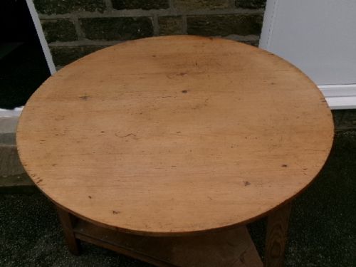 A 19th-century pine cricket table featuring a smooth round top supported by three splayed legs and a triangular undershelf. View V