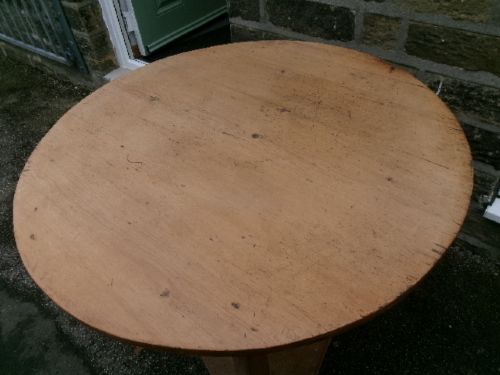 A 19th-century pine cricket table featuring a smooth round top supported by three splayed legs and a triangular undershelf. View VII