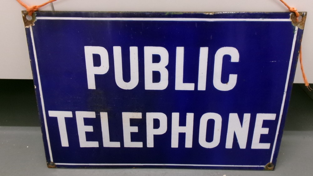A rectangular cobalt blue vitreous enamel sign featuring the words PUBLIC TELEPHONE in bold white block capitals with a white border.