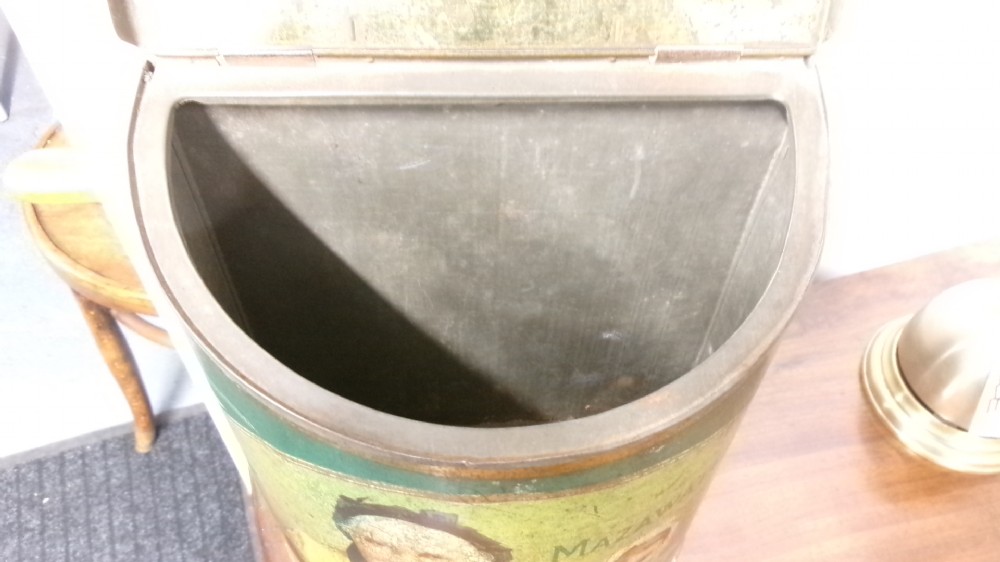 An antique semi-circular green tinplate tea caddy featuring a lithographed illustration of a woman drinking tea within an oval frame. View VI