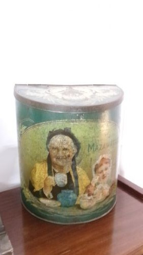 An antique semi-circular green tinplate tea caddy featuring a lithographed illustration of a woman drinking tea within an oval frame. View II