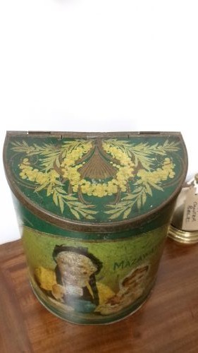 An antique semi-circular green tinplate tea caddy featuring a lithographed illustration of a woman drinking tea within an oval frame. View III
