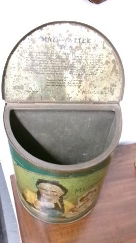 An antique semi-circular green tinplate tea caddy featuring a lithographed illustration of a woman drinking tea within an oval frame. View IV