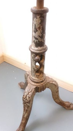 A Victorian revolving stool featuring a circular wooden seat mounted on a cast iron tripod base. View III