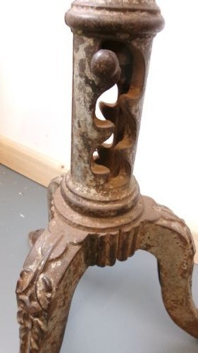 A Victorian revolving stool featuring a circular wooden seat mounted on a cast iron tripod base. View V