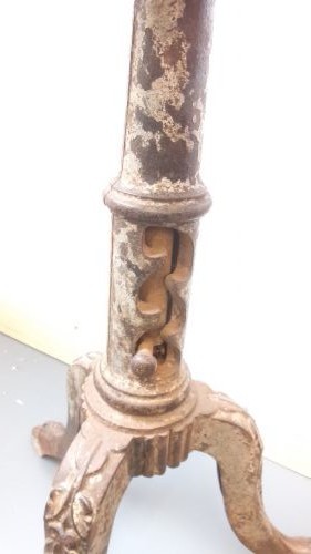 A Victorian revolving stool featuring a circular wooden seat mounted on a cast iron tripod base. View VI