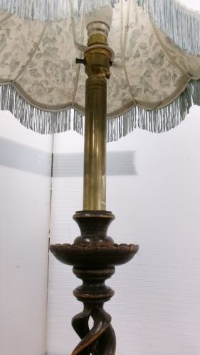 A pair of dark wood table lamps featuring carved barley twist stems, circular bases, and patterned fabric shades with fringed trim. View IV