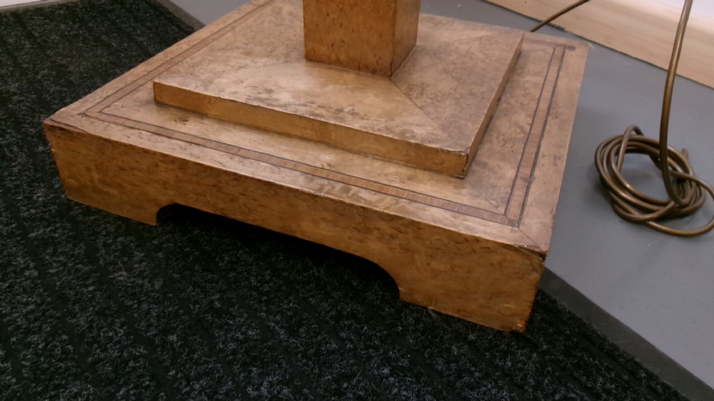 An Art Deco blond walnut standard lamp featuring a geometric stepped column and tiered square base. View VII