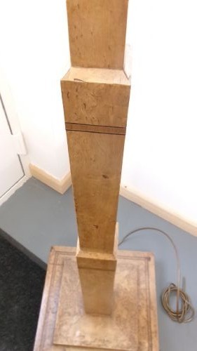 An Art Deco blond walnut standard lamp featuring a geometric stepped column and tiered square base. View II