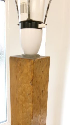 An Art Deco blond walnut standard lamp featuring a geometric stepped column and tiered square base. View V