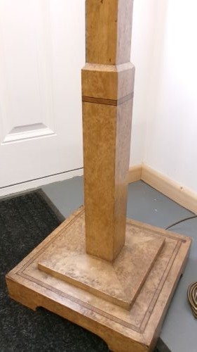 An Art Deco blond walnut standard lamp featuring a geometric stepped column and tiered square base. View VIII