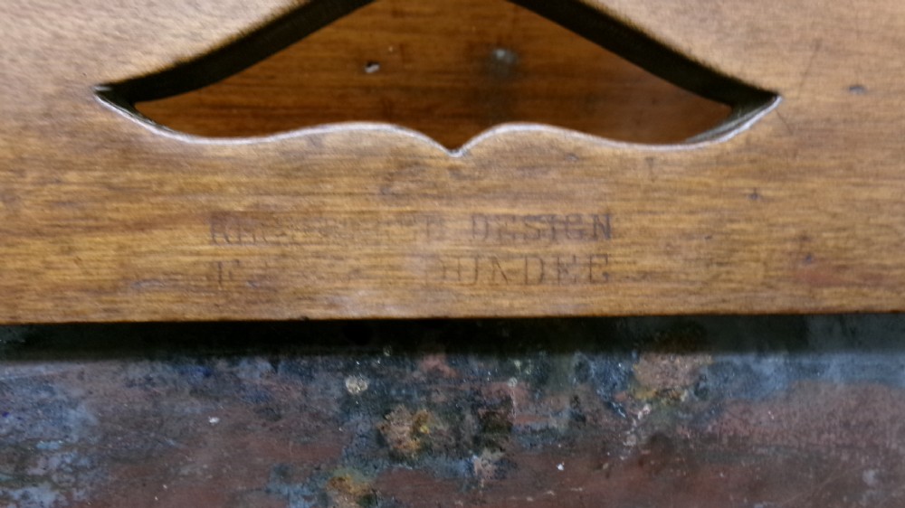 An antique wooden side chair with turned legs featuring an integrated blue and white enamel advertising sign for Watsons Matchless Cleanser Soap set into the backrest. View VII
