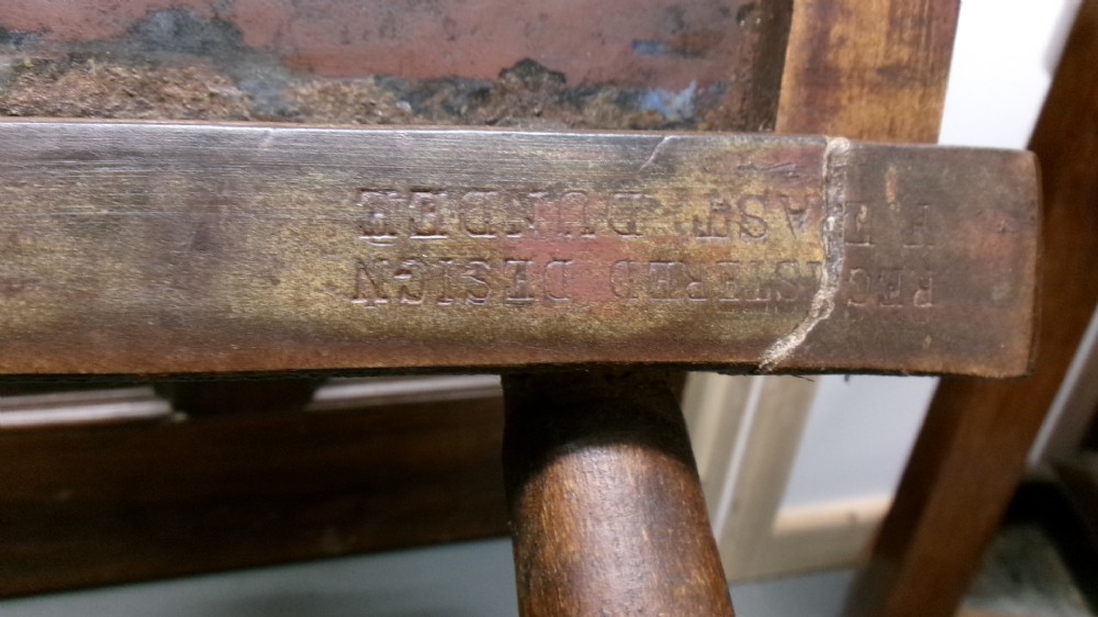 An antique wooden side chair with turned legs featuring an integrated blue and white enamel advertising sign for Watsons Matchless Cleanser Soap set into the backrest. View IX