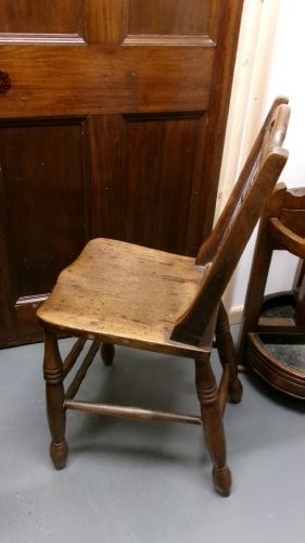 An antique wooden side chair with turned legs featuring an integrated blue and white enamel advertising sign for Watsons Matchless Cleanser Soap set into the backrest. View X