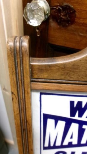 An antique wooden side chair with turned legs featuring an integrated blue and white enamel advertising sign for Watsons Matchless Cleanser Soap set into the backrest. View XI