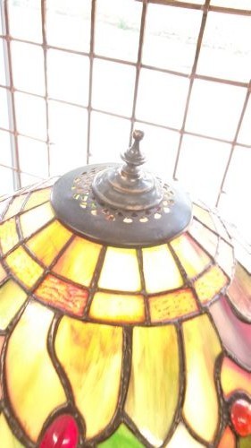 A tall Edwardian brass table lamp featuring an open twist stem and a Tiffany style stained glass dragonfly lampshade. View VI