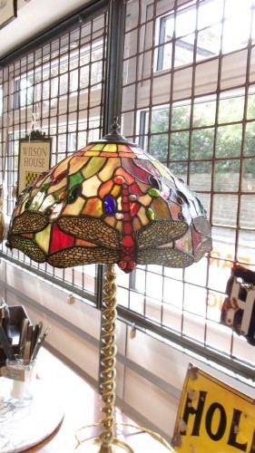 A tall Edwardian brass table lamp featuring an open twist stem and a Tiffany style stained glass dragonfly lampshade. View VIII