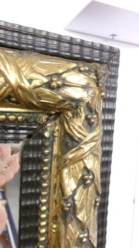 A rectangular Victorian wall mirror featuring a dark wooden frame bordered with ornate gilt brass foliate leaf moulding. View VII