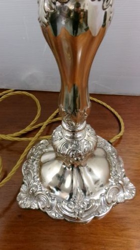 An Edwardian silver-plated table lamp base featuring Rococo scrollwork, a shaped baluster stem, and a moulded plinth base. View III