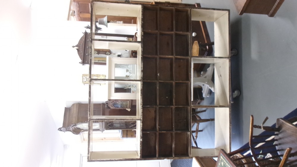 A pair of large Victorian painted shop fitting units featuring open cubby shelves and multiple dark wood drawers with round knobs. View V