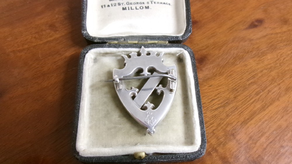A Victorian silver shield-shaped brooch inlaid with pink and grey agate stones and set with faceted citrines and a central cabochon gemstone. View III