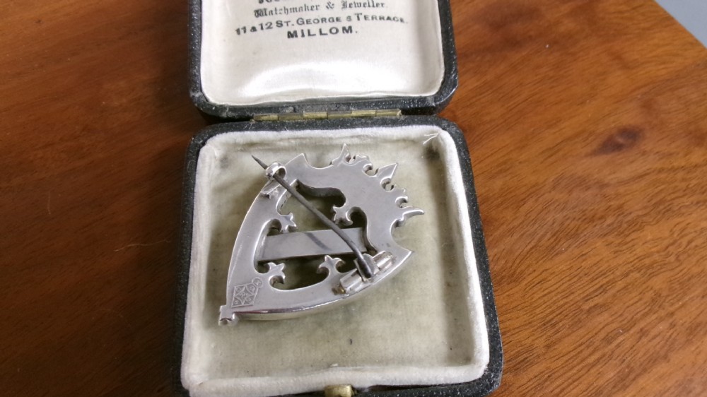 A Victorian silver shield-shaped brooch inlaid with pink and grey agate stones and set with faceted citrines and a central cabochon gemstone. View VII