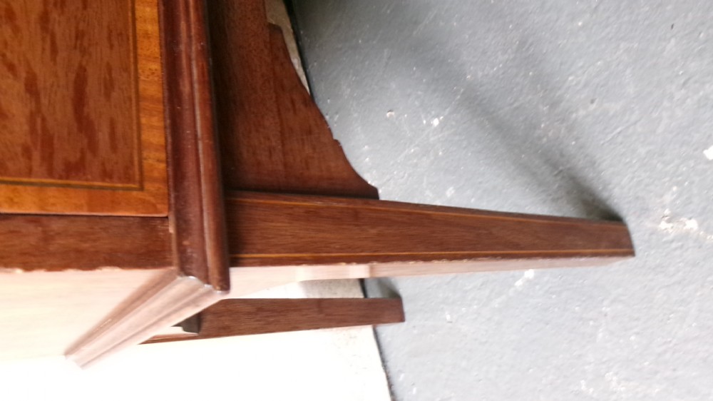 An Edwardian open mahogany bookcase featuring three shelves above a single drawer decorated with floral inlay. View II