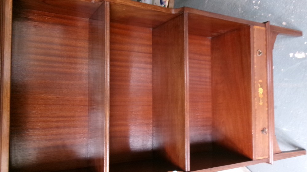 An Edwardian open mahogany bookcase featuring three shelves above a single drawer decorated with floral inlay. View IV