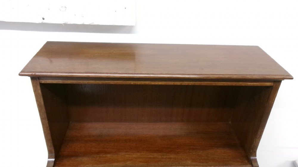 An Edwardian open mahogany bookcase featuring three shelves above a single drawer decorated with floral inlay. View VI