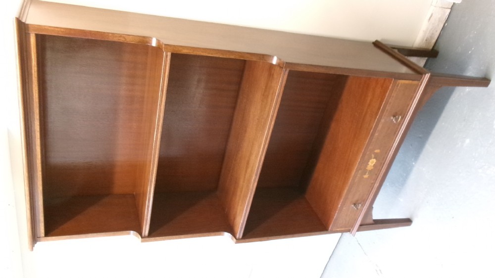 An Edwardian open mahogany bookcase featuring three shelves above a single drawer decorated with floral inlay. View VII