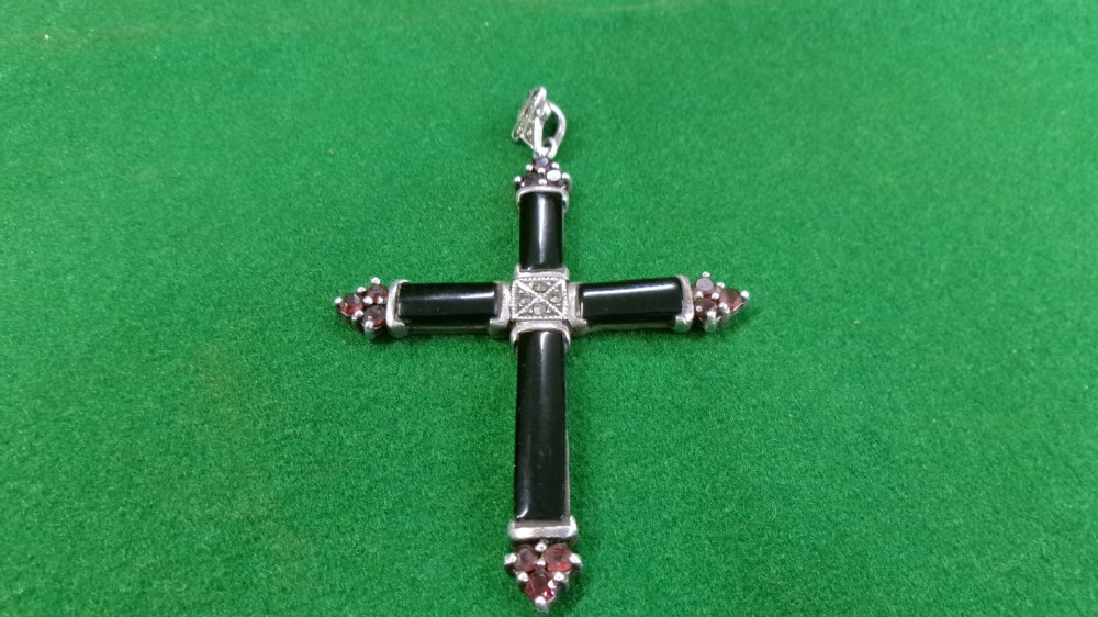 A sterling silver cross pendant featuring black rectangular stone panels, red stone cluster terminals, and marcasite settings on the central junction and bale. View IV