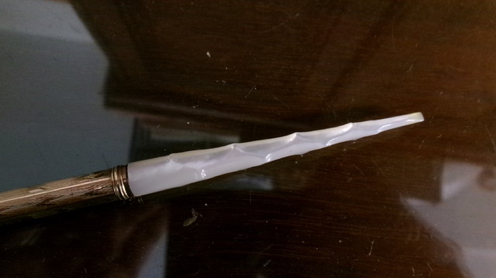 A Victorian Mabie Todd & Co gold-plated dip pen featuring an engraved metal barrel, metal nib, and a carved white handle. View II
