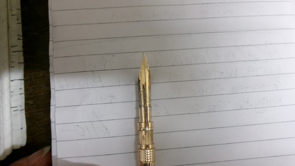 A Victorian Mabie Todd & Co gold-plated dip pen featuring an engraved metal barrel, metal nib, and a carved white handle. View III