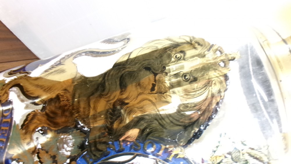 A large clear glass Victorian apothecary jar featuring a gilded coat of arms and arrowroot inscription topped with a fitted domed brass lid. View II