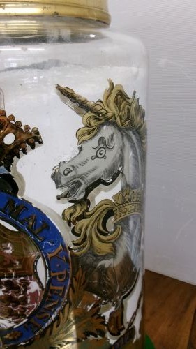 A large clear glass Victorian apothecary jar featuring a gilded coat of arms and arrowroot inscription topped with a fitted domed brass lid. View IV