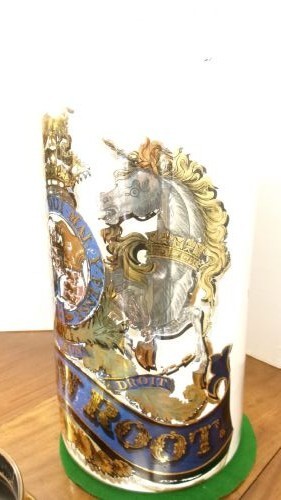 A large clear glass Victorian apothecary jar featuring a gilded coat of arms and arrowroot inscription topped with a fitted domed brass lid. View IX