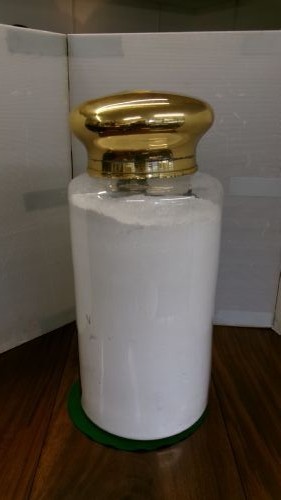A large clear glass Victorian apothecary jar featuring a gilded coat of arms and arrowroot inscription topped with a fitted domed brass lid. View XIV