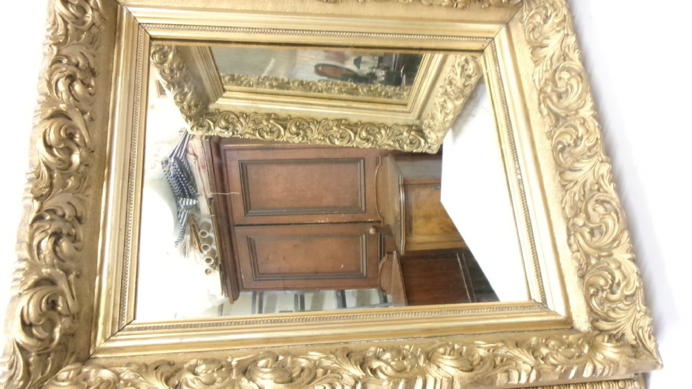 A pair of rectangular giltwood wall mirrors featuring heavily carved frame borders with acanthus leaf scrolling and beaded inner moulding. View III