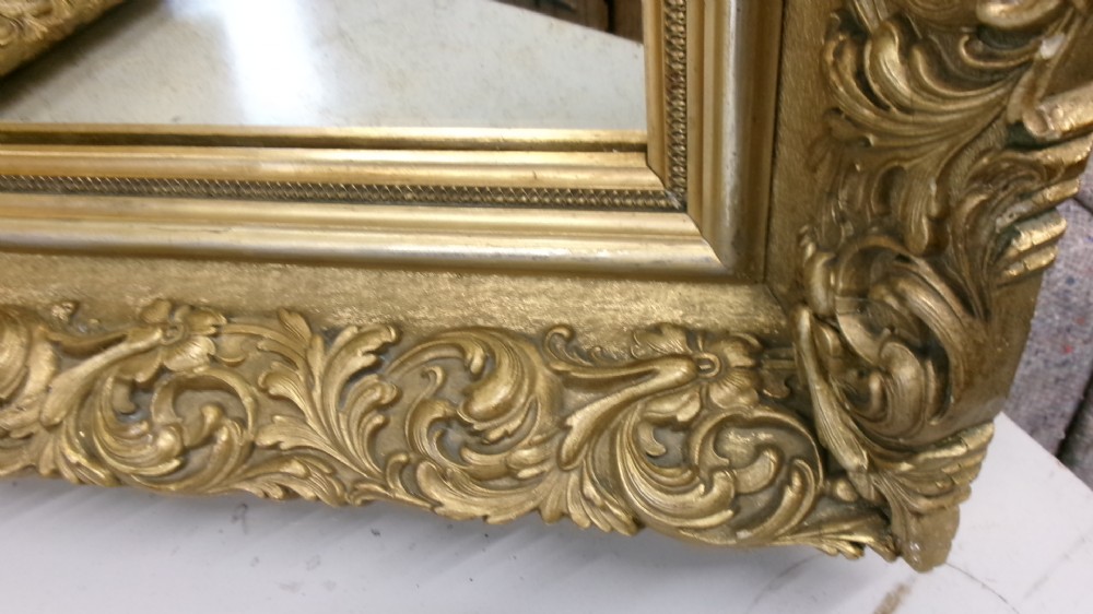 A pair of rectangular giltwood wall mirrors featuring heavily carved frame borders with acanthus leaf scrolling and beaded inner moulding. View IV