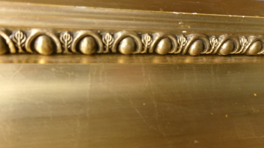 A pair of rectangular giltwood wall mirrors featuring heavily carved frame borders with acanthus leaf scrolling and beaded inner moulding. View V