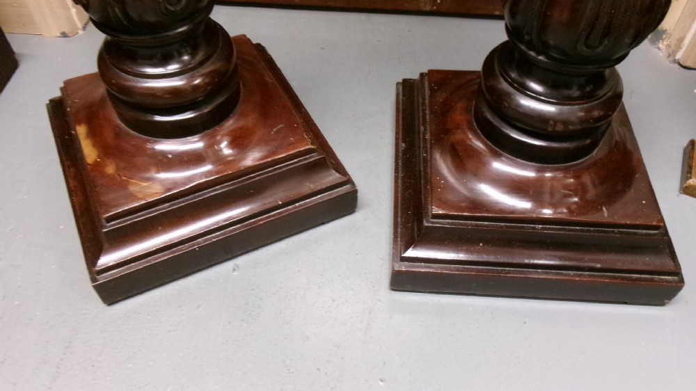 A pair of tall Victorian dark mahogany torchere stands featuring circular dished tops, spiral acanthus leaf carved shafts, and square plinth bases. View IV