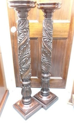 A pair of tall Victorian dark mahogany torchere stands featuring circular dished tops, spiral acanthus leaf carved shafts, and square plinth bases. View VI