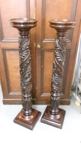A pair of tall Victorian dark mahogany torchere stands featuring circular dished tops, spiral acanthus leaf carved shafts, and square plinth bases. View VII
