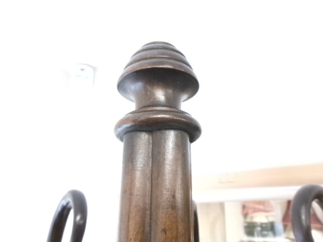 A dark brown bentwood hat and coat stand featuring multiple curved upper hooks, a circular ring, and a four-legged splayed base. View V