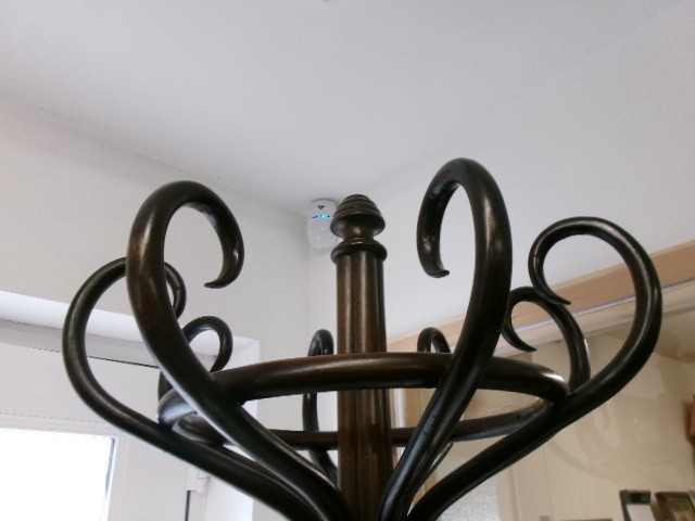 A dark brown bentwood hat and coat stand featuring multiple curved upper hooks, a circular ring, and a four-legged splayed base. View VI