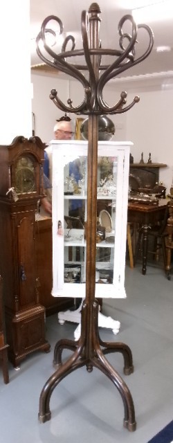 A dark brown bentwood hat and coat stand featuring multiple curved upper hooks, a circular ring, and a four-legged splayed base. View VII